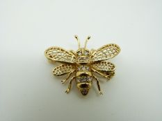An 18ct gold brooch/ pendant in the form of an insect set with diamonds to the body,