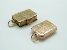 A yellow metal charm in the form of a book with chased foliate decoration and a hallmarked 9ct gold