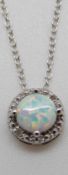 A silver necklace set with an opal cabochon and diamonds