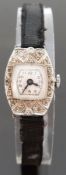 Art Deco platinum ladies cocktail wristwatch with Arabic numerals, black hands and diamond set case,