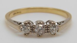 An 18ct gold ring set with three round cut diamonds (size R)