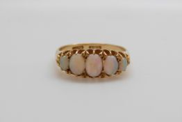 An 18ct gold ring set with five graduated opals,