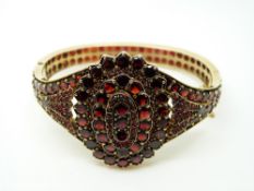 A Victorian bangle set with garnets