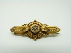 A Victorian yellow metal brooch set with diamonds in a flower setting, 4.