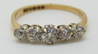 An 18ct gold ring set with five old cut diamonds, the largest approximately 0.25ct, 2.