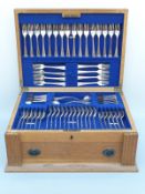 A George V 12 place setting oak cased canteen of hallmarked silver cutlery in the King James or