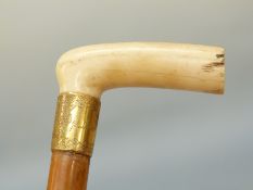 A carved ivory-handled malacca cane with 18ct gold mounts