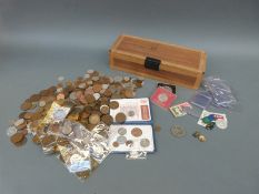 A collection of UK coinage in a wooden box, to include farthings, Queen Victoria pennies,