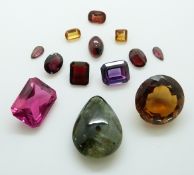 A collection of gemstones including a mixed cut synthetic ruby, an emerald cut purple sapphire,