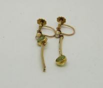 A pair of yellow metal earrings in a stylised flower design