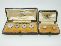 A set of four 9ct gold and platinum buttons set with mother of pearl and sapphires to the centre in