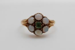 A Victorian 15ct gold ring set with a square cut peridot surrounded by opals (size M/N)