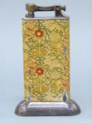 A Dunhill enamelled table lighter with floral decoration,