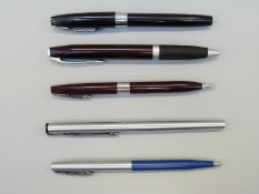 Five Sheaffer White Dot pens and pencils comprising stainless steel fountain pen,