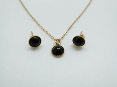 A 9ct gold pendant set with onyx and matching earrings