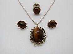 A 9ct gold pendant set with tiger's eye and matching earrings