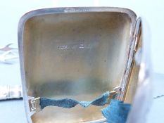 A hallmarked silver cigarette case and sugar tongs, weight 68g,