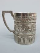 A Victorian hallmarked silver mug with Egyptian revival or Indian/Eastern decoration,