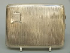An Art Deco engine turned curved hallmarked silver cigarette case, Birmingham 1935,