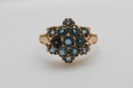 A 9ct gold ring set with blue topaz in a cluster (size N)