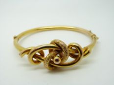 A 9ct gold Victorian bangle with textured knotted design, 10.