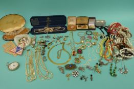 A collection of costume jewellery to include faux pearls, brooches, pearl necklace, glass beads,
