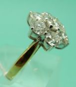 An 18ct gold ring set with seven round brilliant cut diamonds,