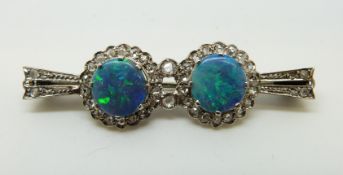 An Art Deco 9ct white gold brooch set with two opal doublets surrounded by rose cut diamonds, 4.