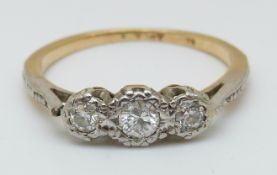 An 18ct gold ring set with three diamonds in a platinum setting, 2.