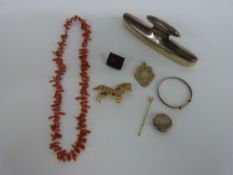 A carved jet brooch, silver mounted buffer, Victorian button, coral necklace,