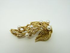 A Grosse 18ct gold brooch with textured detail set with pearls in a textured setting
