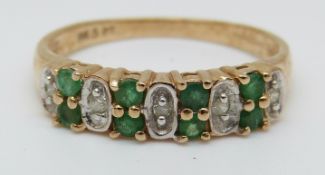 A 9ct gold ring set with a emeralds and diamonds (size P)