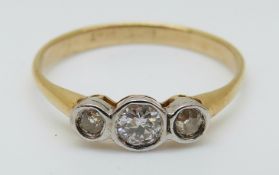 An 18ct gold ring set with three diamonds in a platinum setting, 1.