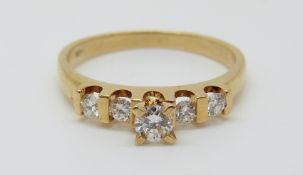 An 18ct gold ring set with five diamonds, 2.