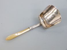 A Georgian hallmarked silver and mother of pearl caddy spoon formed as a shovel,