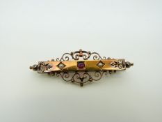 A Victorian 15ct gold brooch set with a ruby and two seed pearls, 4.