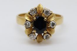 An 18ct gold ring set with an oval sapphire of approximately 0.