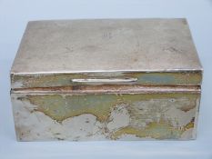 An Edward VII hallmarked silver cigarette box, London 1909 maker's mark rubbed, length 13.