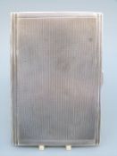 An Art Deco hallmarked silver engine turned cigarette case,