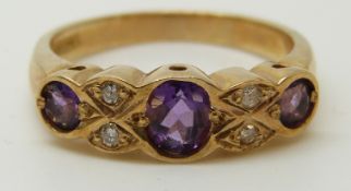 A 9ct gold ring set with amethysts and diamonds (size M)