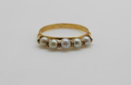 A French 18ct gold ring set with five pearls, 1.