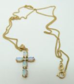 A 9ct gold pendant set with opals in a cross on a 9ct gold chain, 3.