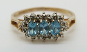 A 9ct gold ring set with blue topaz surrounded by diamonds