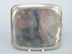 A George V hallmarked silver curved cigarette case, Birmingham 1922,