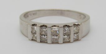 An 18ct white gold ring set with square diamonds, 3.