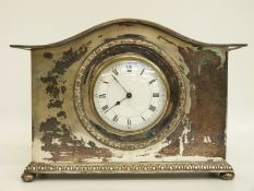 A French silver plated mantel clock with Roman white dial and Arabic quarters, raised on bun feet,
