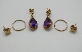 A pair of 9ct gold earrings set with amethysts and a pair of 9ct gold studs, 4.
