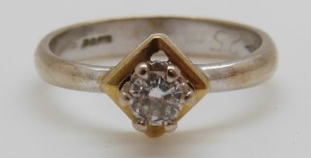 An 18ct white gold ring set with a round brilliant cut diamond of approximately 0.
