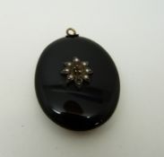 A Victorian French jet pendant set with pearls verso a glass compartment,