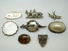 An Edwardian silver brooch with bird and foliate design, a Victorian swallow brooch,
